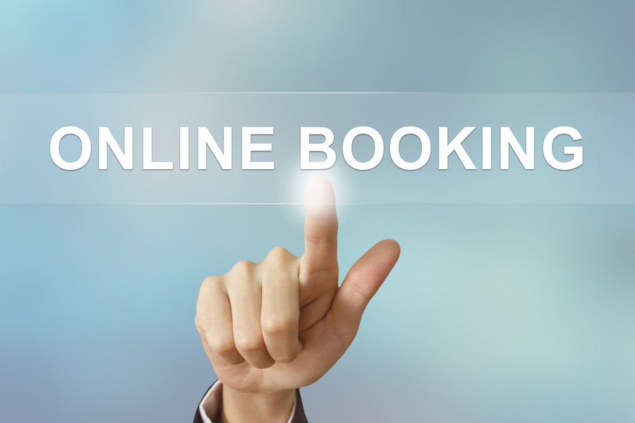 business hand clicking online booking button